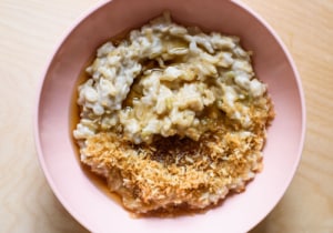 Basmati Rice Pudding with Toasted Coconut Flakes and Maple Syrup in a pink bowl