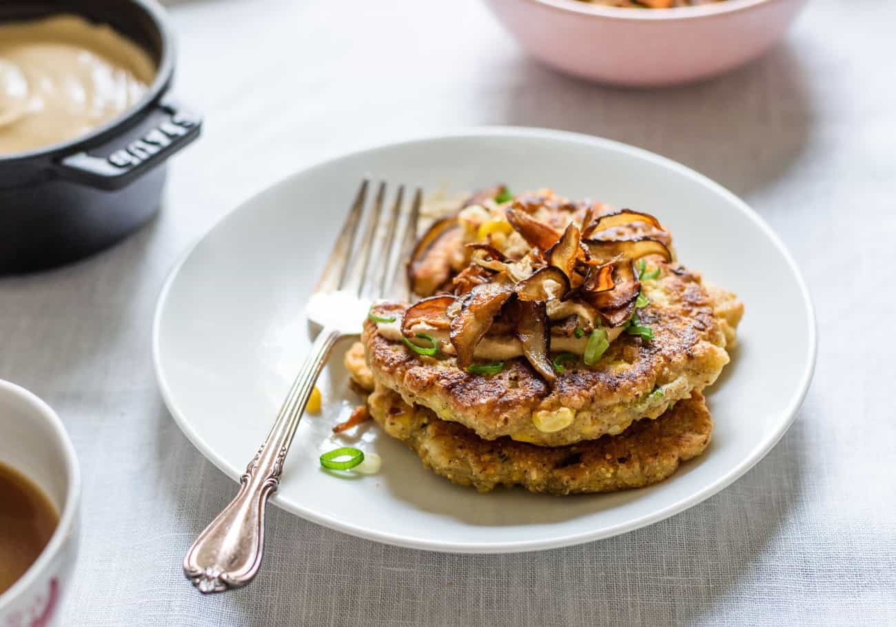 Savory Corn Pancakes with Shiitake 'Bacon' and Chipotle Cashew Cream on a white plate