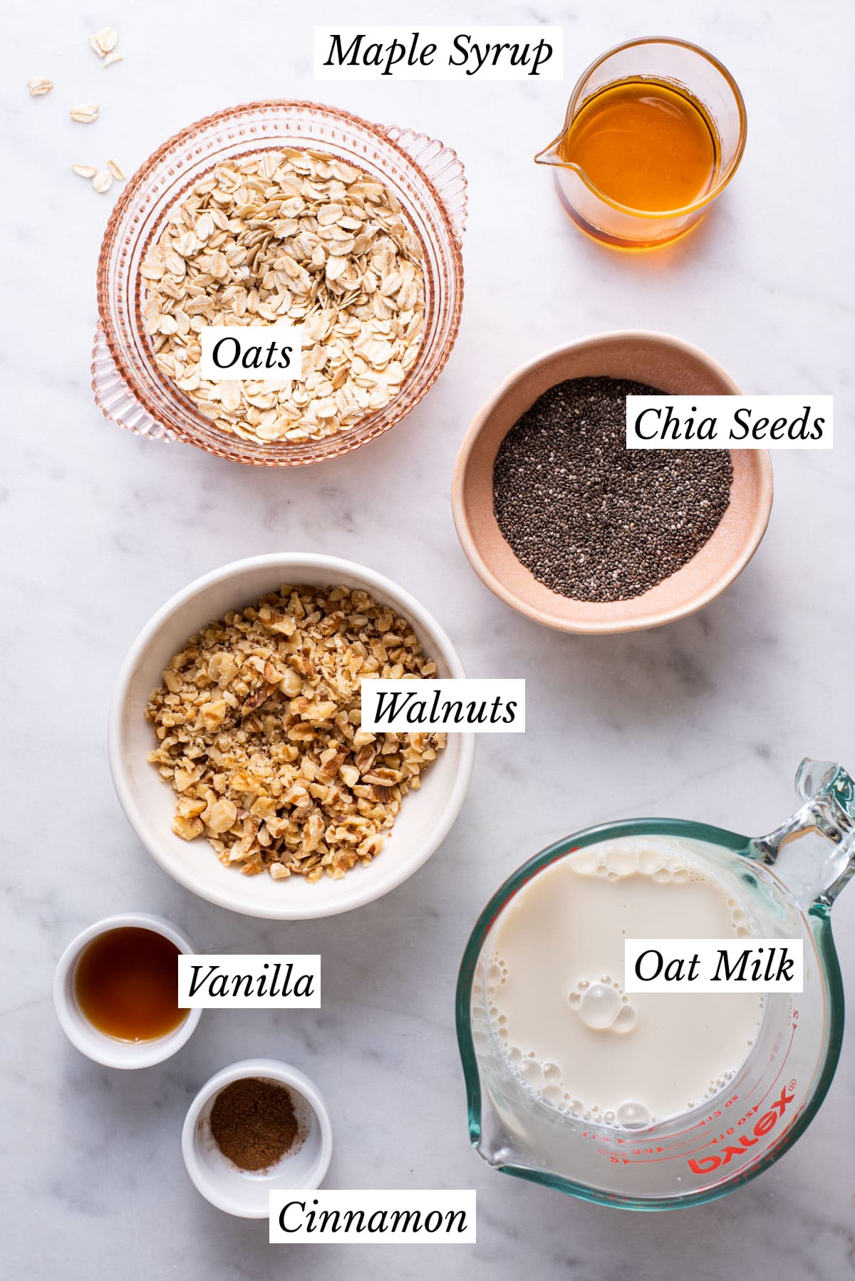 Ingredients gathered to make basic overnight oats with chia seeds laid out on a marble table.
