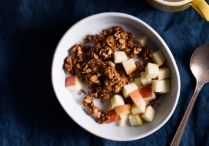 Tahini granola in a bowl on a blue tablecloth