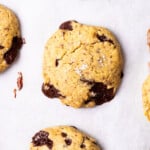 Closeup of vegan chickpea chocolate chip cookies on parchment paper.