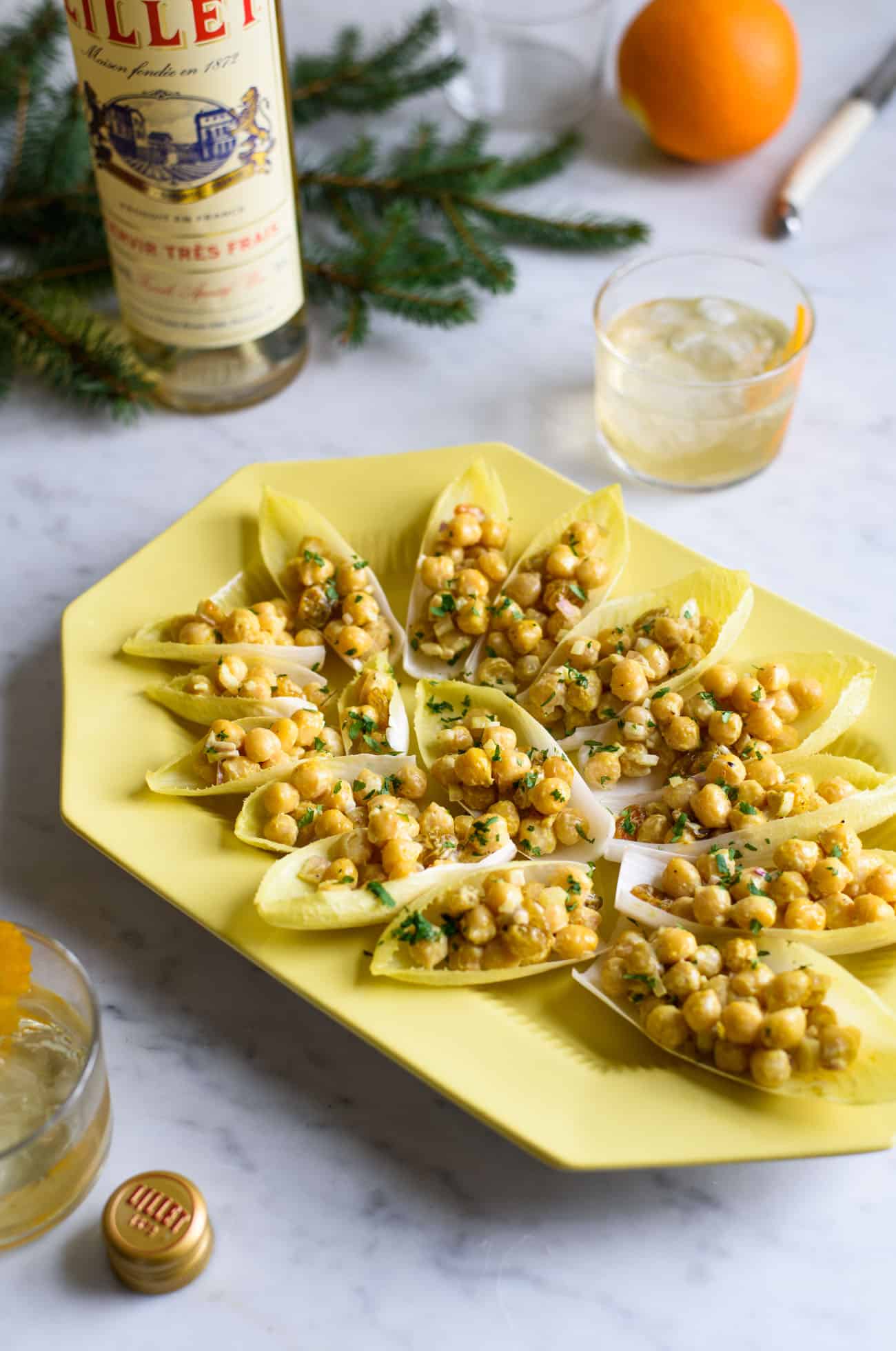 Curried Chickpea Salad in Endive Spears on an antique yellow platter