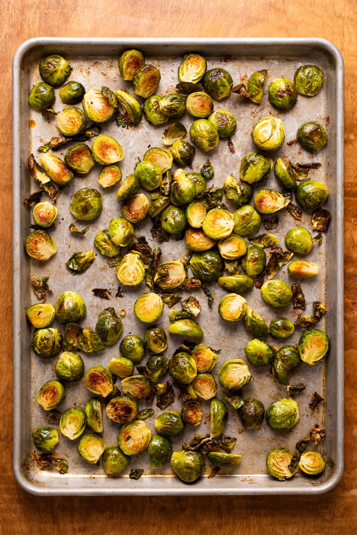 Charred Brussels sprouts on a baking sheet.