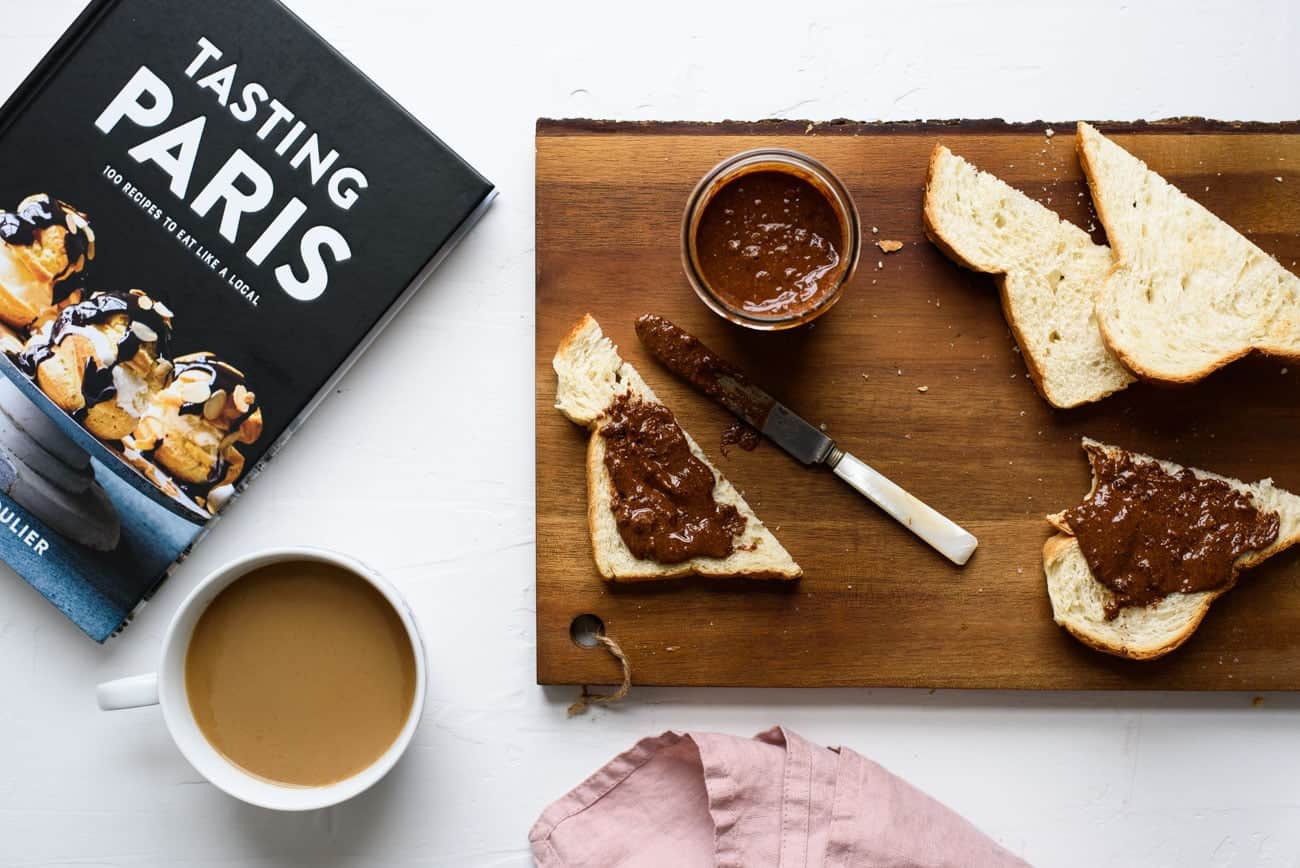 Homemade chocolate hazelnut spread (DIY Nutella) on toast on a wooden cutting board