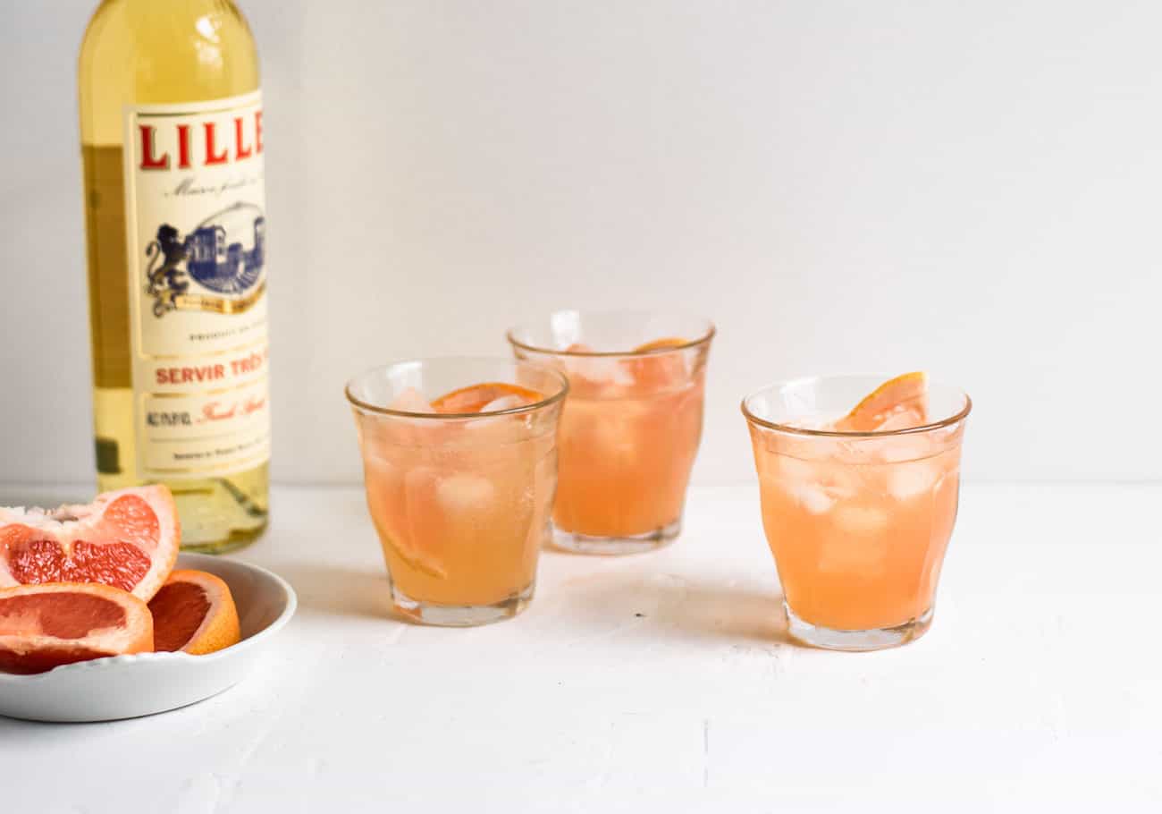 3 glasses of Grapefruit-Lillet Spritzer on white table