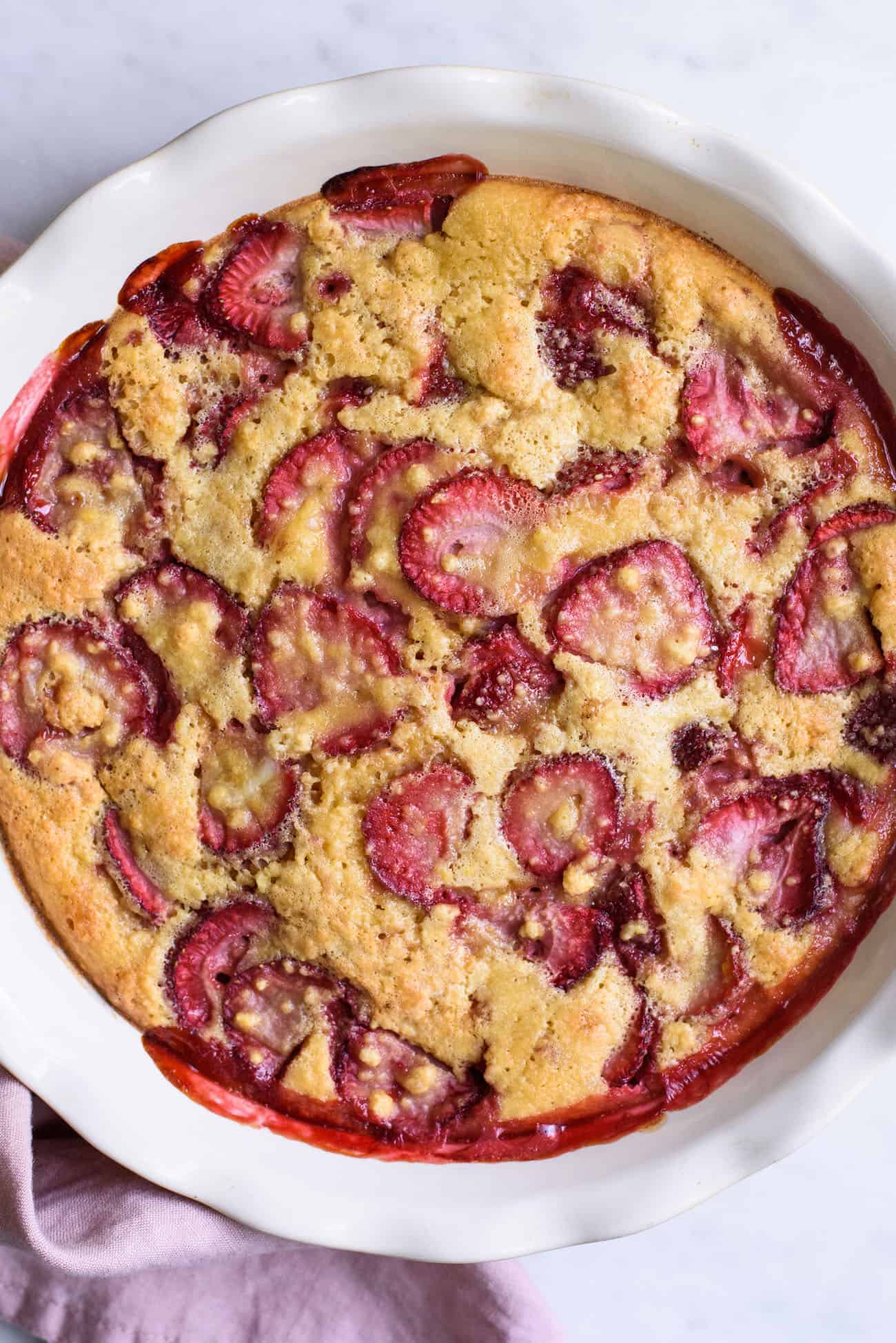 Close-up of strawberry clafoutis in ceramic pie dish
