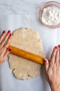 Woman's hands rolling out vegan pot pie crust