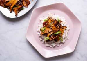 Soy-maple glazed trumpet mushrooms over brown rice with scallions and sesame seeds