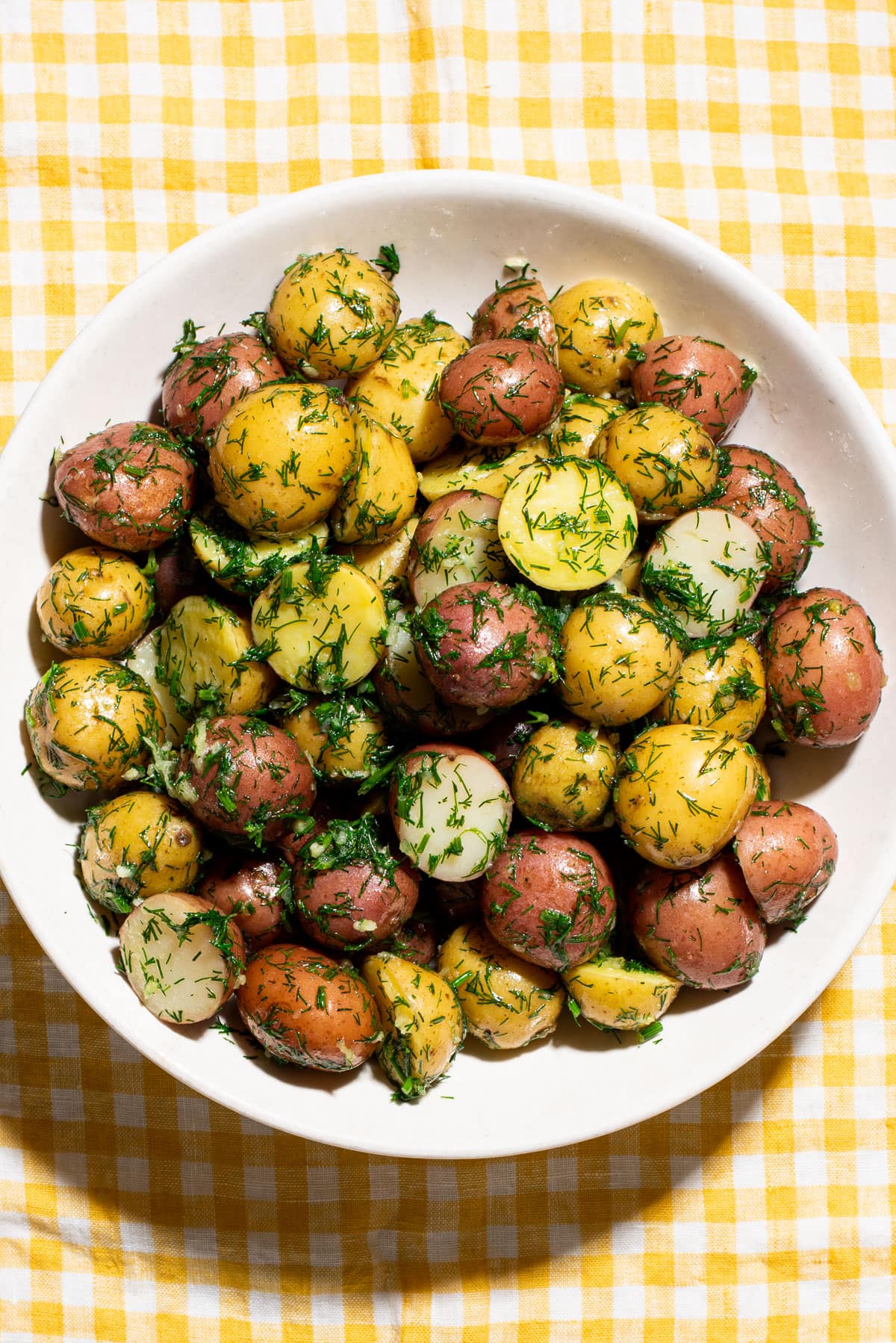 Ukrainian dill potatoes on a yellow gingham tablecloth.