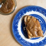 Sourdough toast with peanut butter and apple butter on a vintage blue willow plate