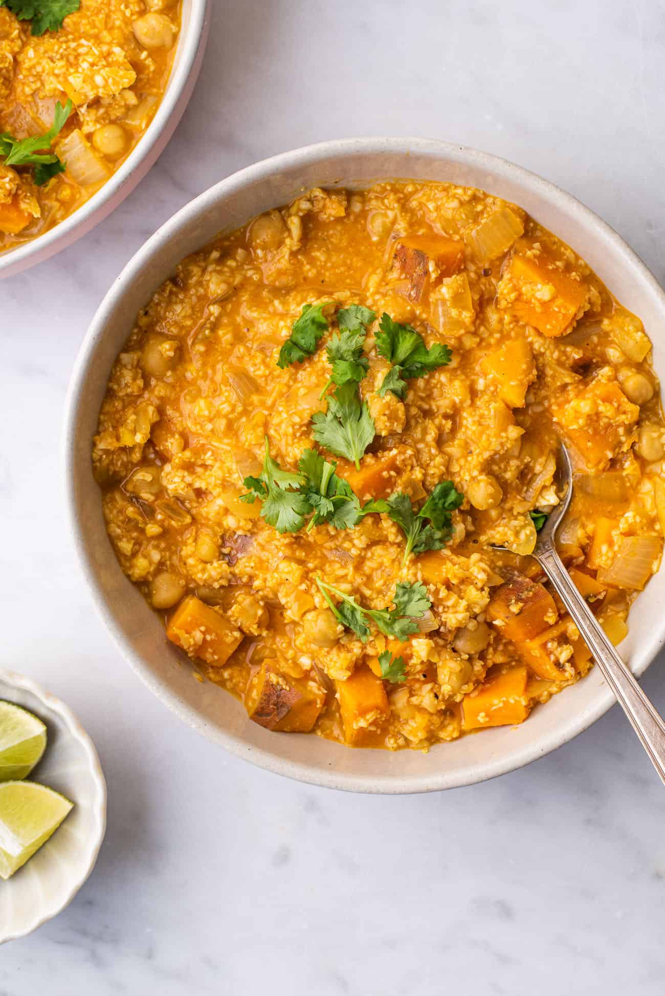 Cauliflower rice curry in a bowl garnished with cilantro
