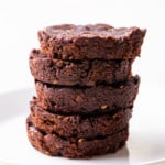 Stack of round brownies on a white plate