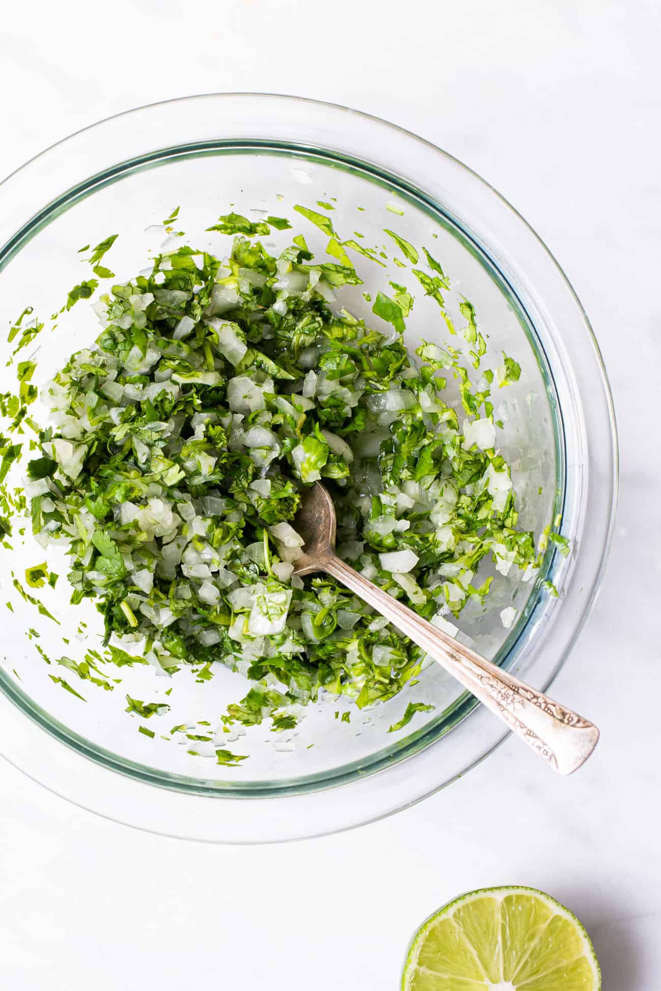 Cilantro-onion relish for tacos, in a glass bowl.
