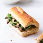 Vegan balsamic portobello sandwich on a baguette with arugula.