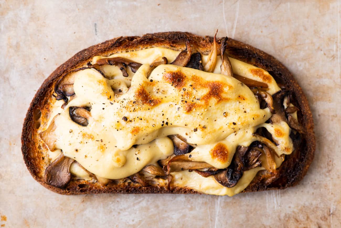 Broiled open-faced vegan mushroom toast with melty "cheese" sauce.
