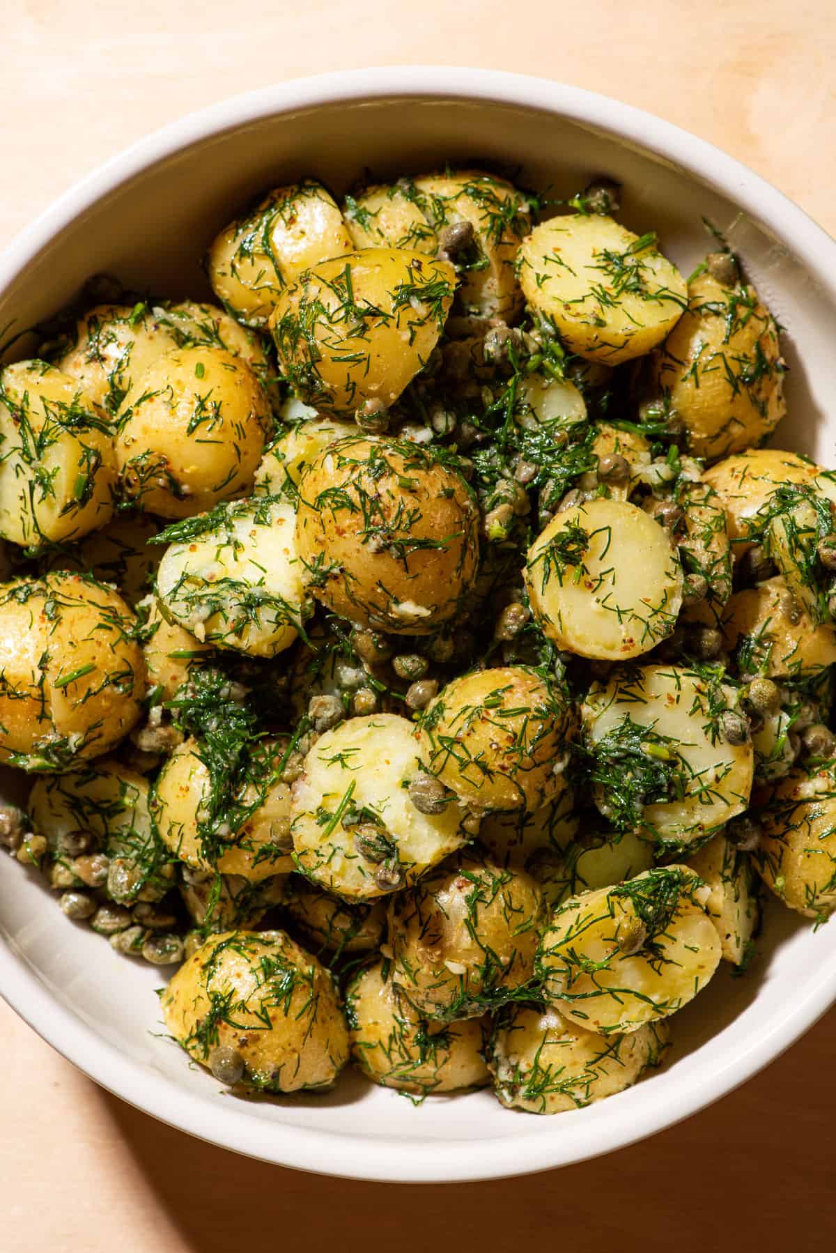Bowl of French-style herbed potato salad with dill and capers (no mayo).