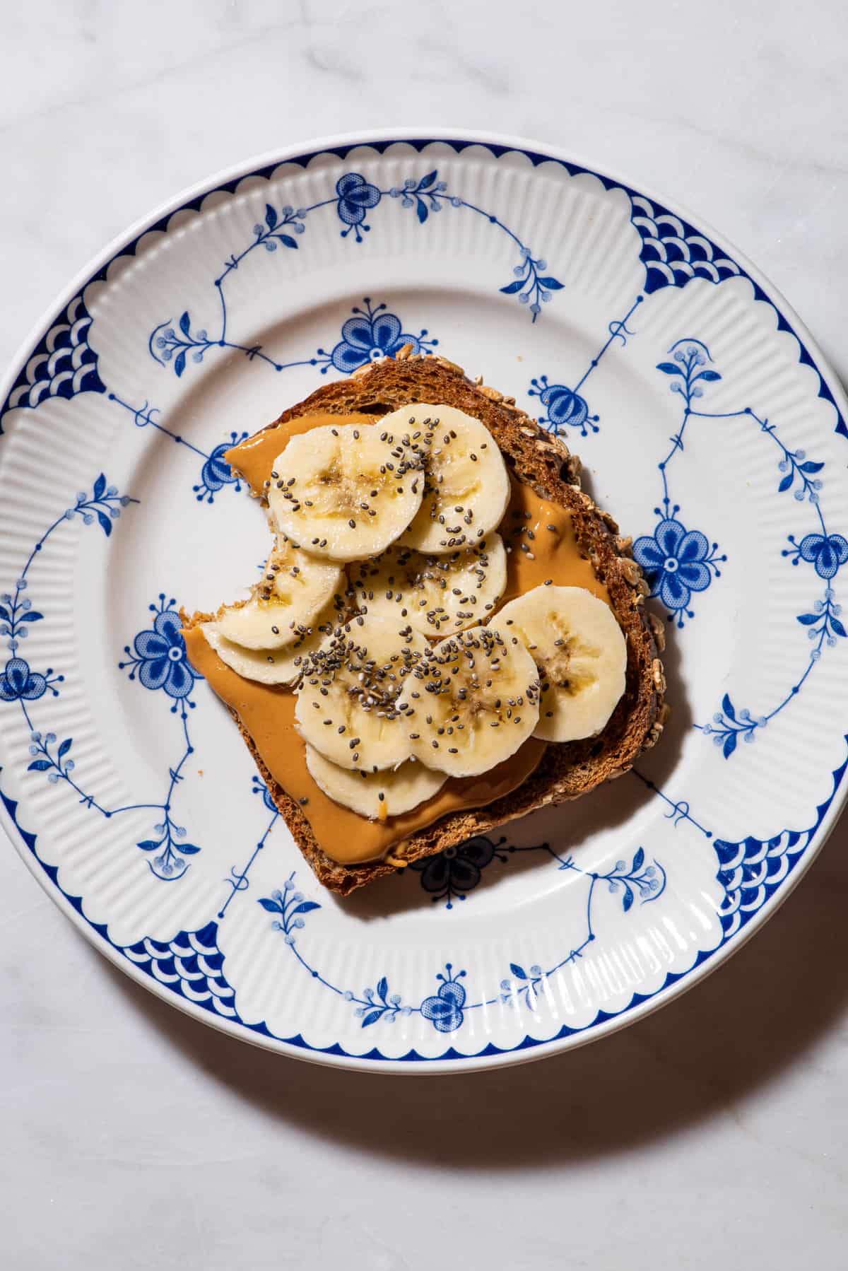 Peanut butter toast with banana slices and chia seeds.