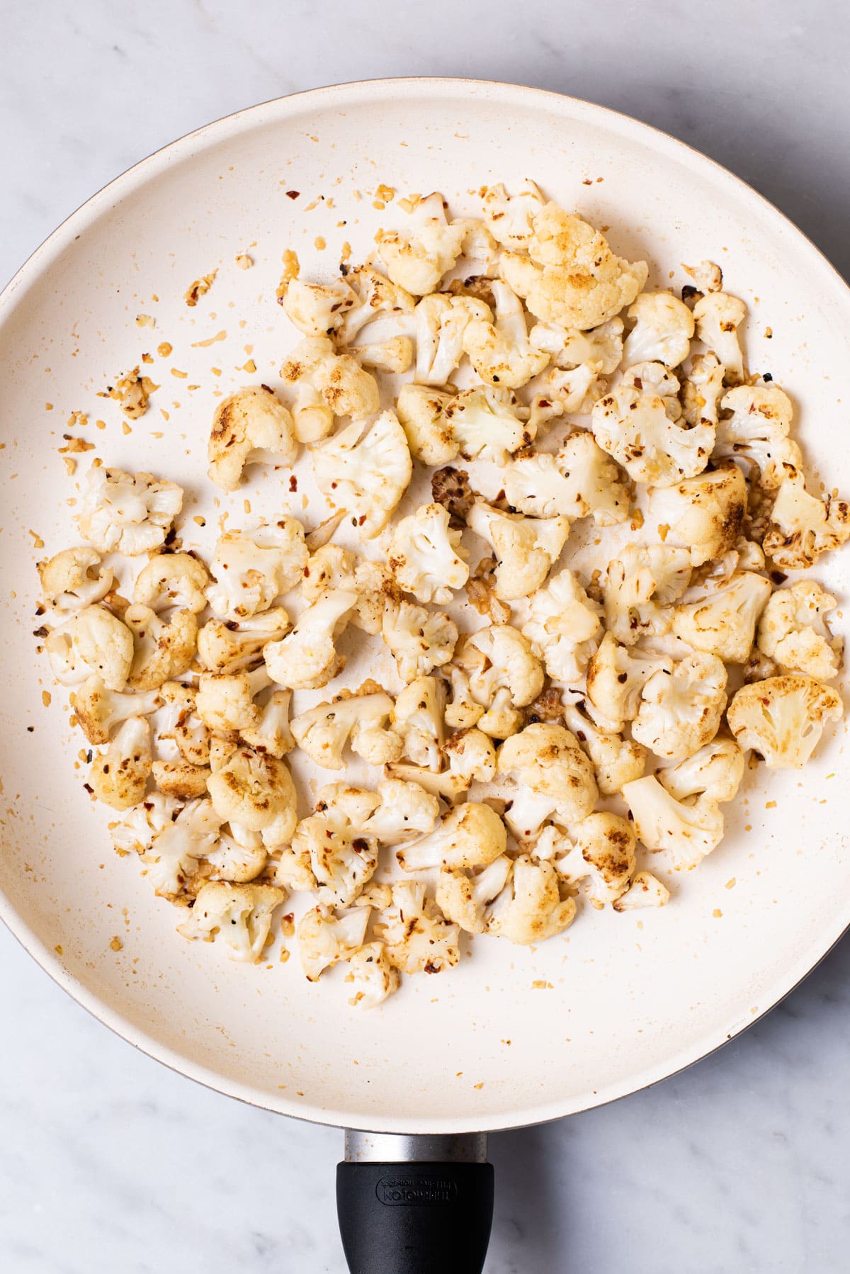 Sauteed cauliflower in a skillet.