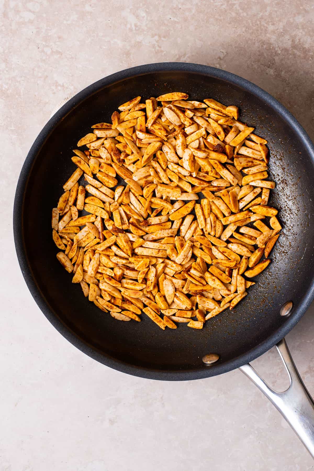 Spiced toasted slivered almonds in a small skillet.