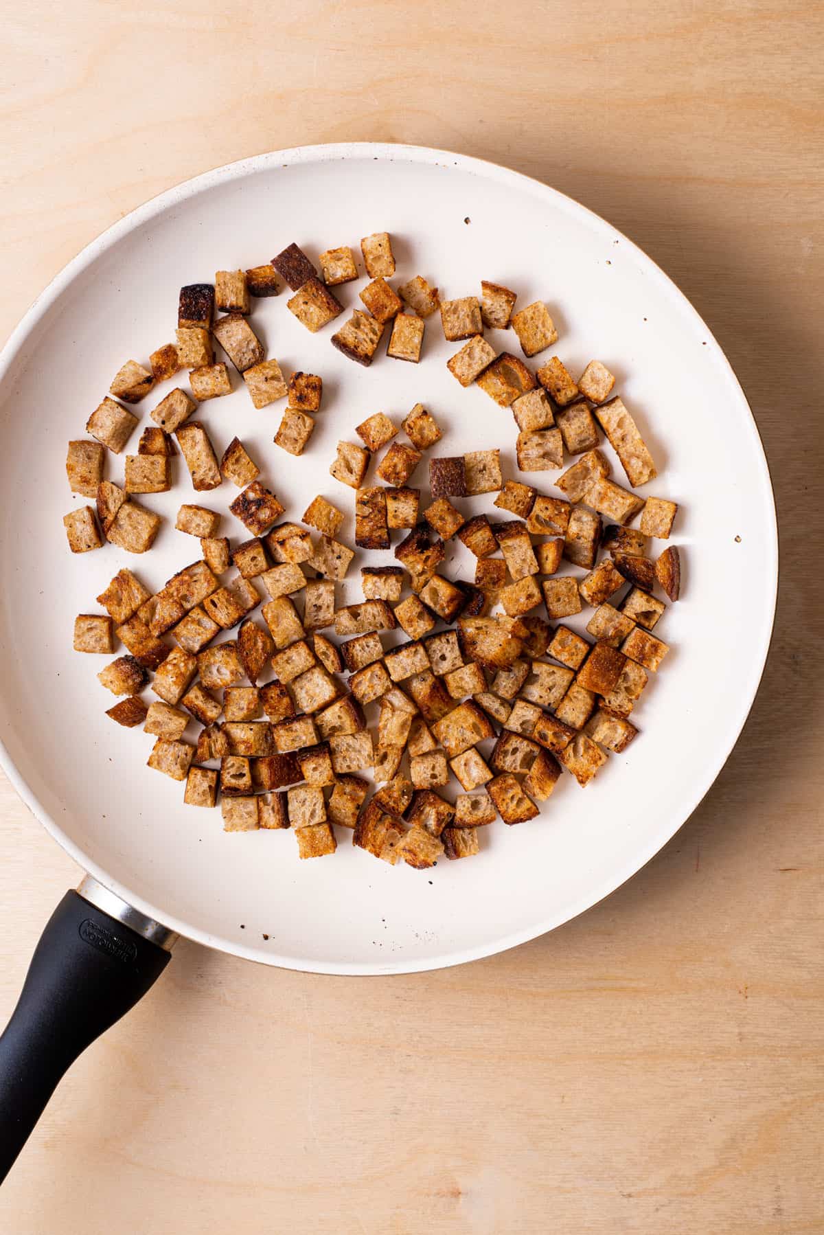 Homemade croutons in a skillet.