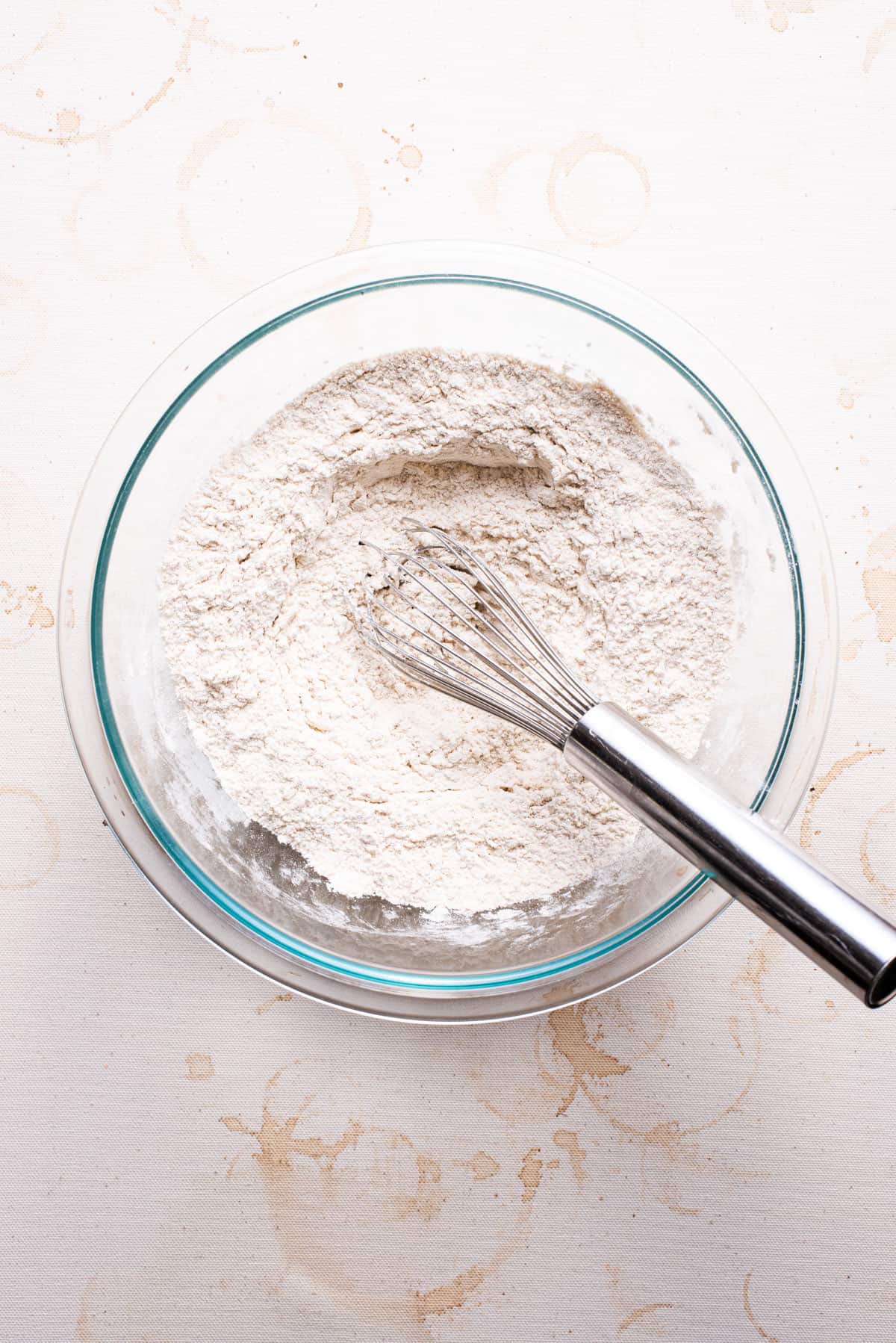 Flour in a bowl with a whisk.
