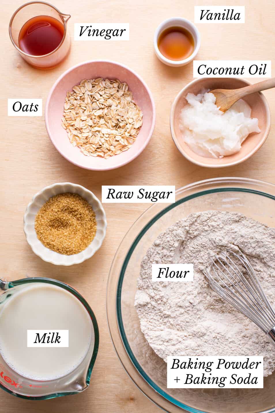 Ingredients gathered on a wooden table to make oat waffles.