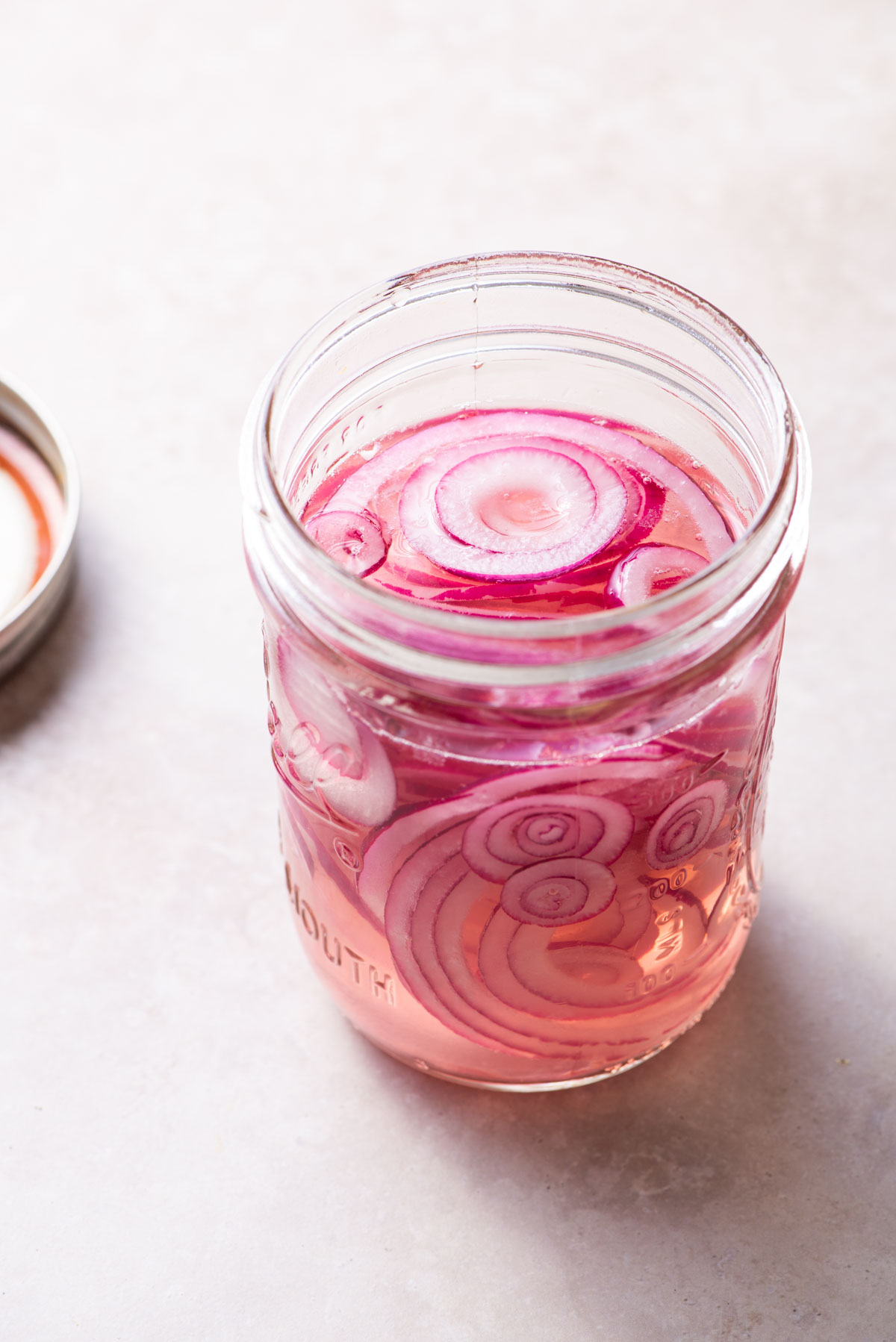 Quick-pickled red onions in a mason jar.