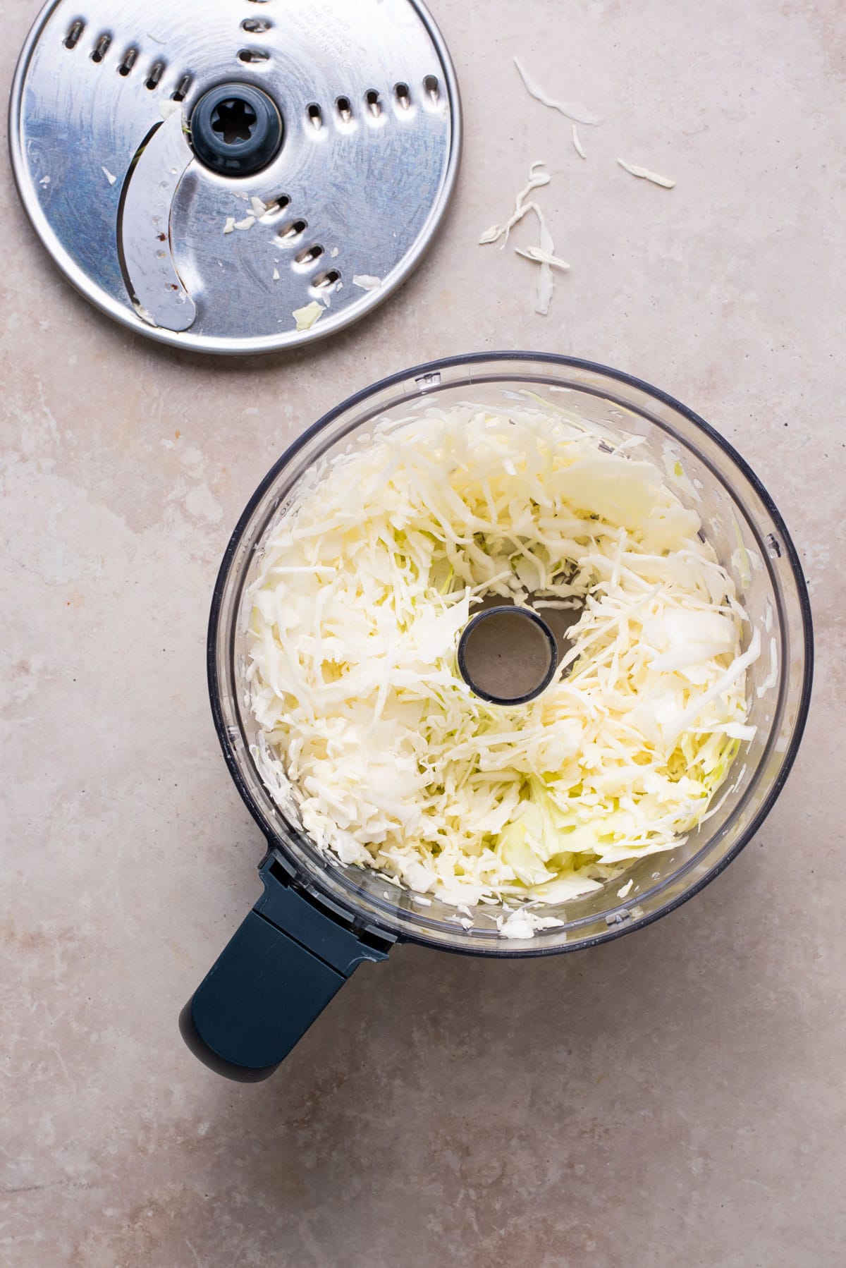 Shredded cabbage in a food processor.