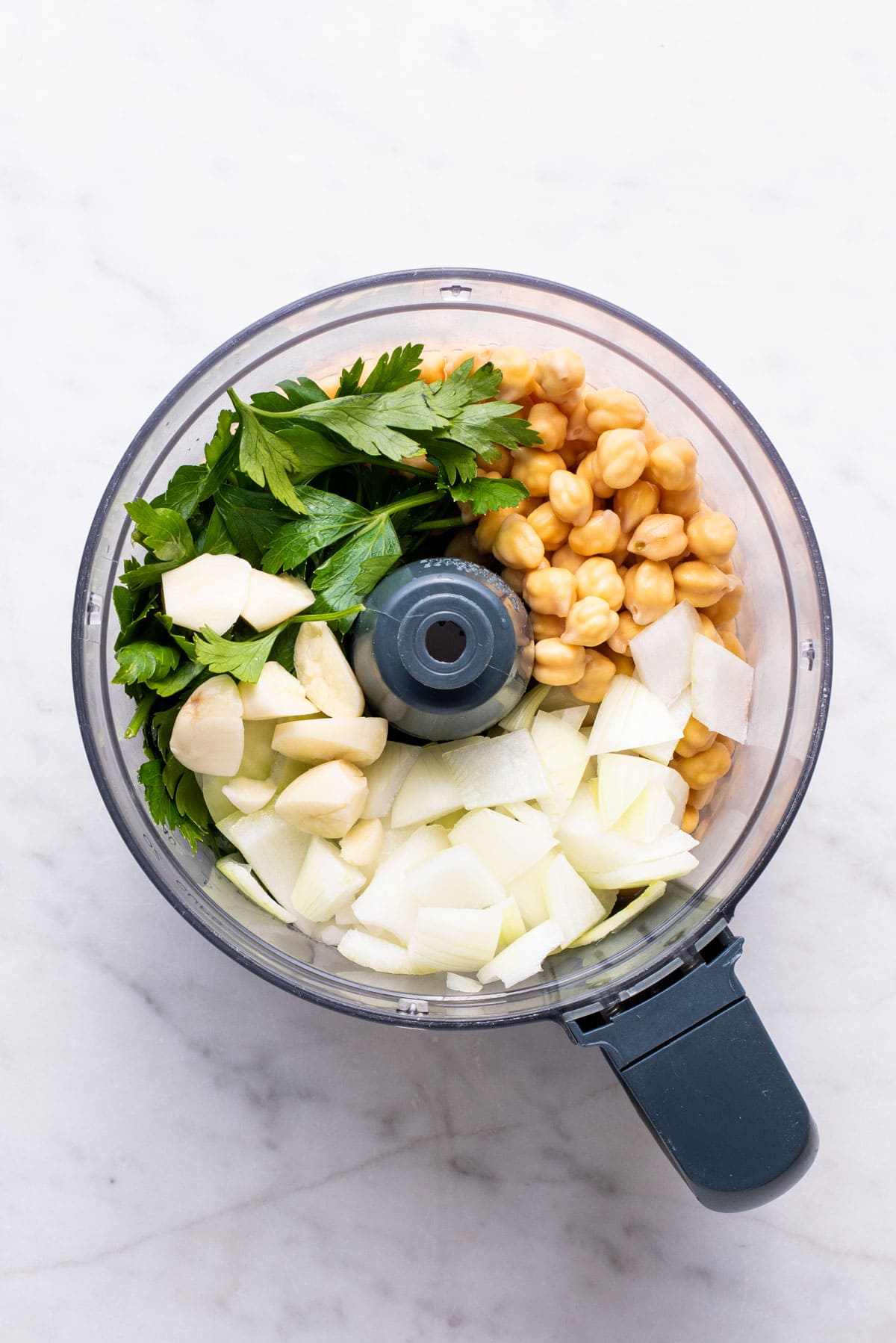 Chickpeas, parsley, garlic and onion in a food processor.