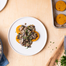 Baked polenta rounds (made with tube polenta) topped with creamy mushroom sauce.