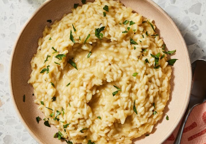 creamy vegan risotto garnished with parsley.