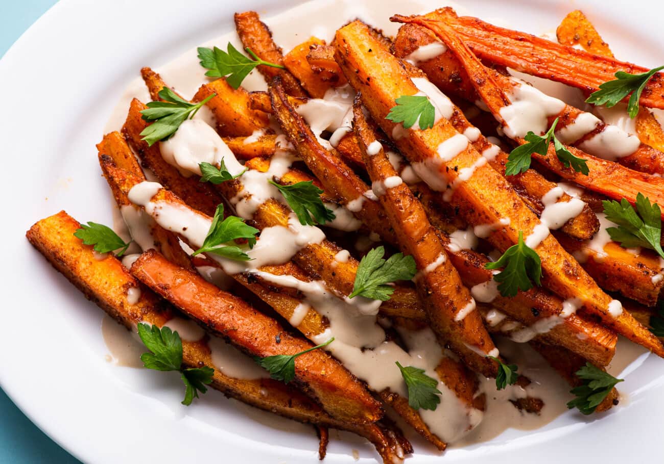 Spiced roasted carrots drizzled with tahini sauce.