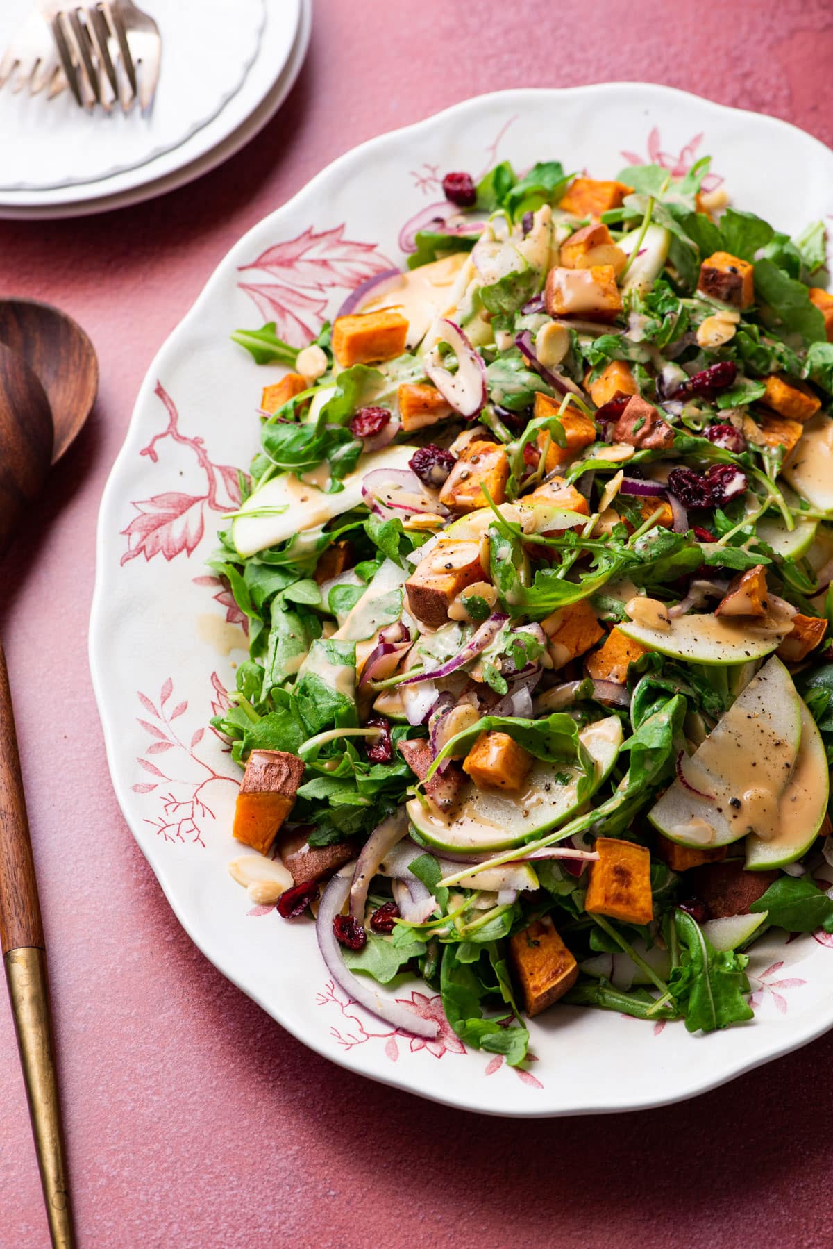 Arugula apple salad with sweet potatoes, cranberries, and balsamic dressing.