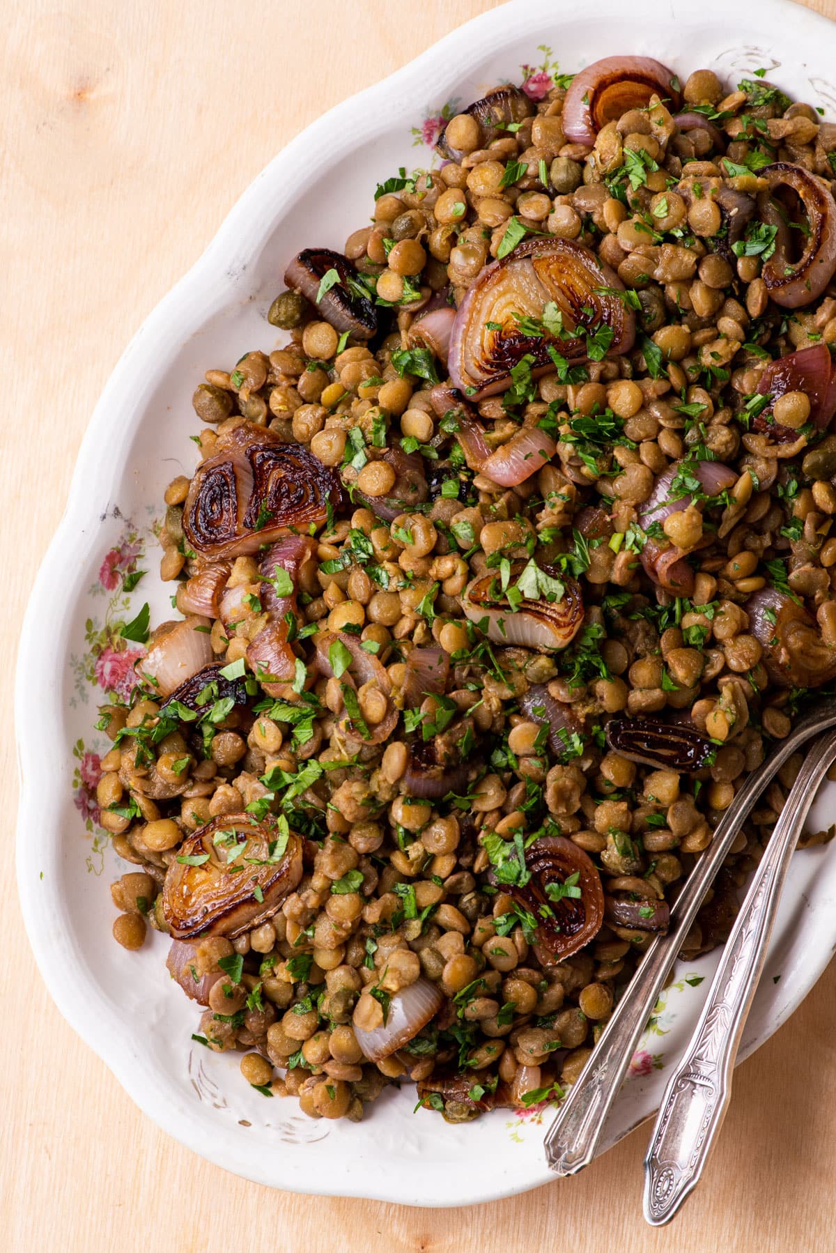 Vegan lentil salad with shallots, capers, and parsley.