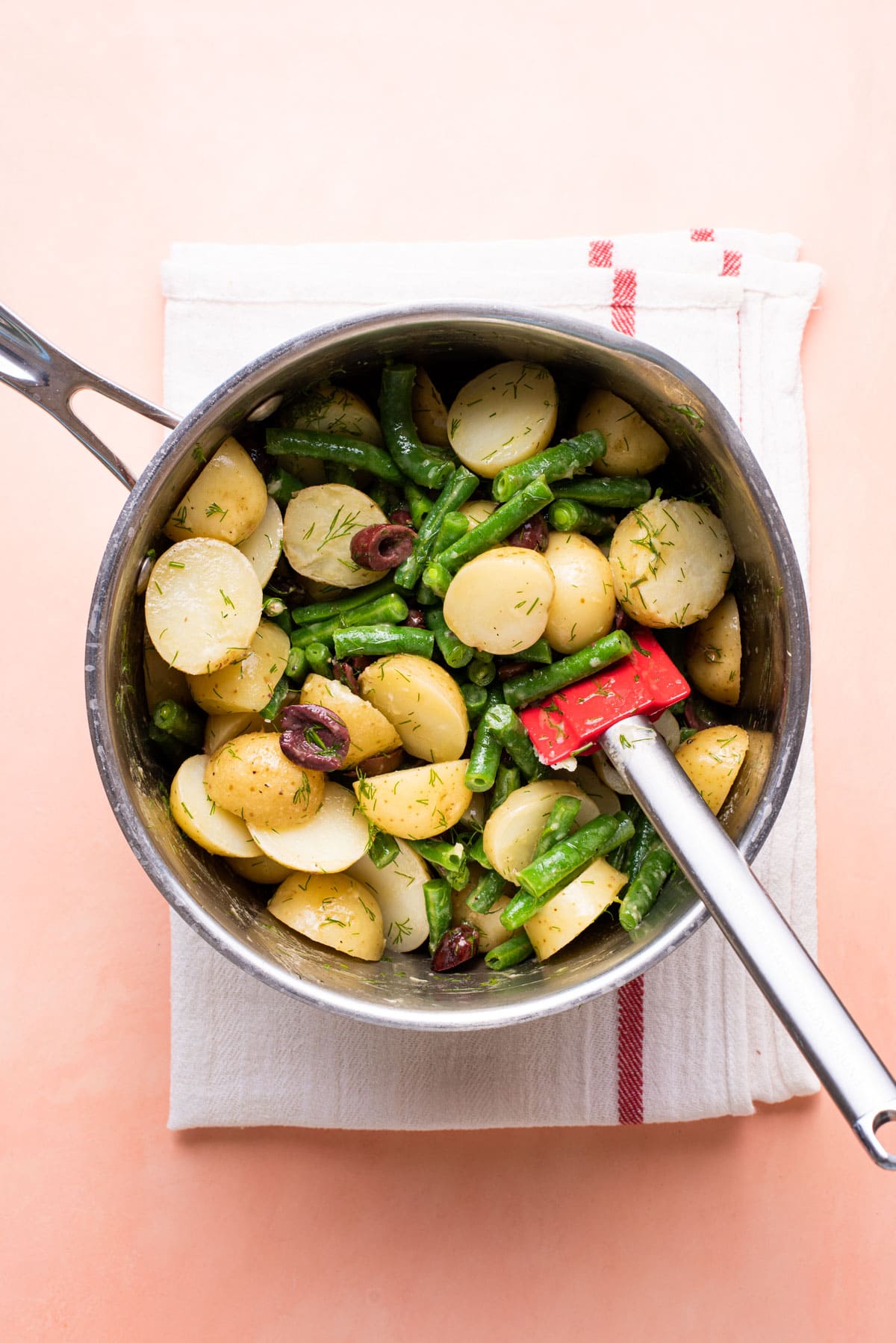 No-mayo potato salad with green beans and olives, mixed together in a pot.