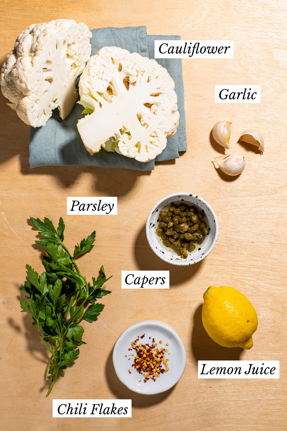 Ingredients gathered to make Mediterranean cauliflower with lemon, capers and parsley.