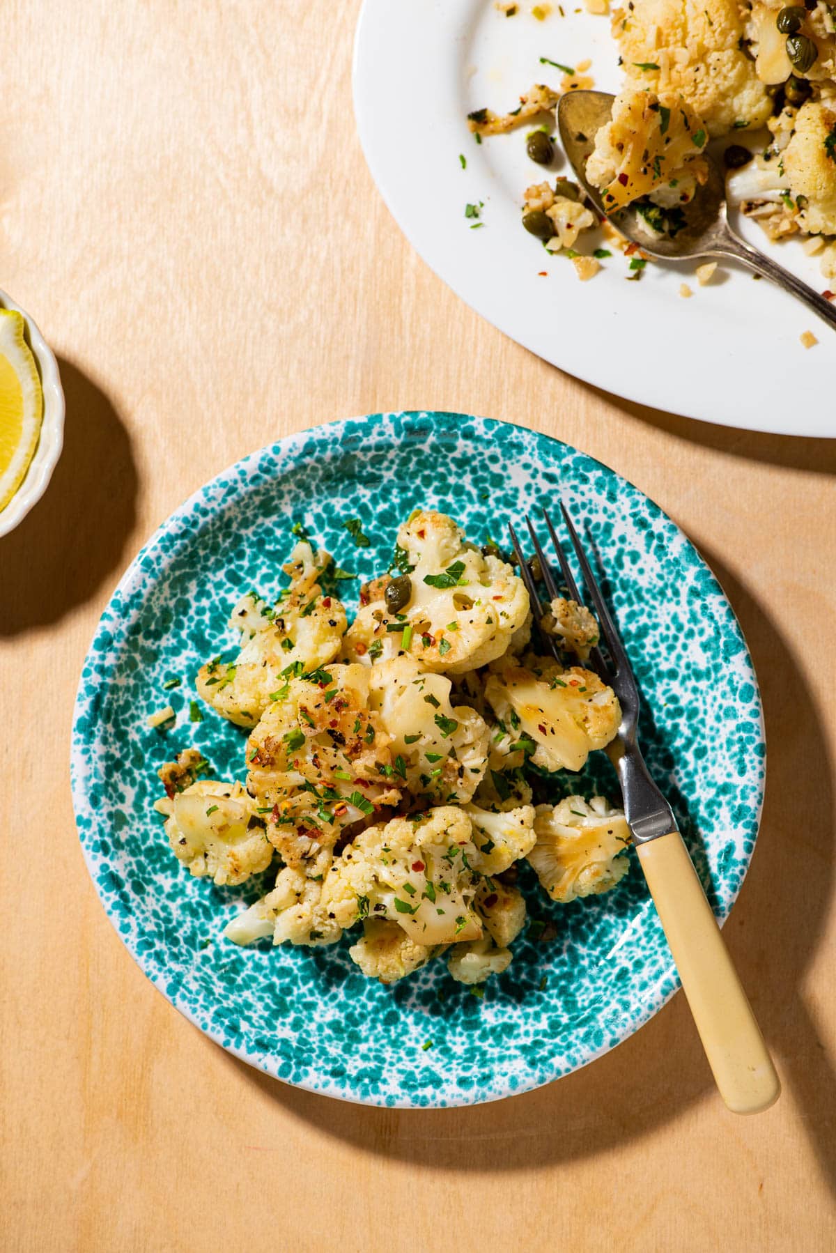 Lemony cauliflower with capers on Italian blue splatter plate.