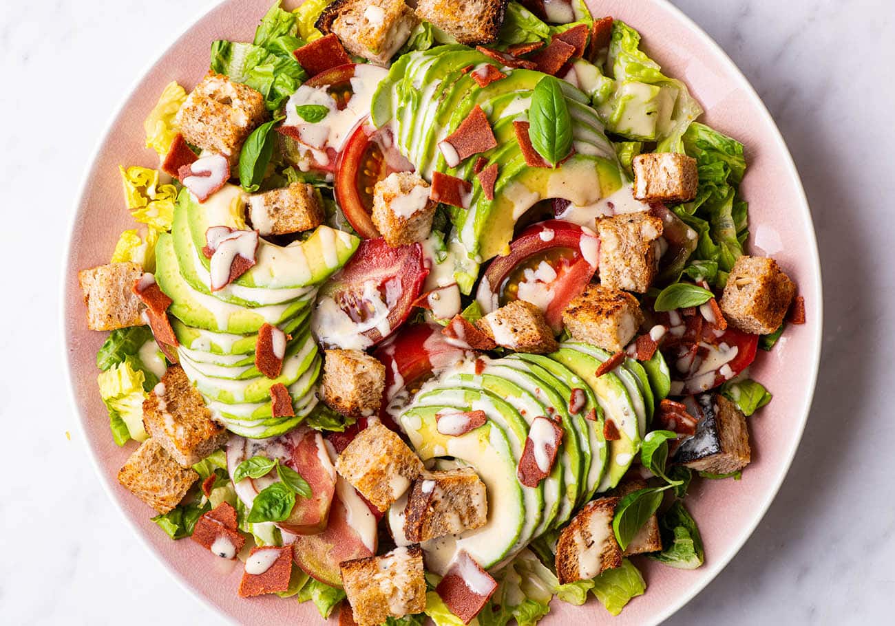 Vegan BLT salad on a pink platter.