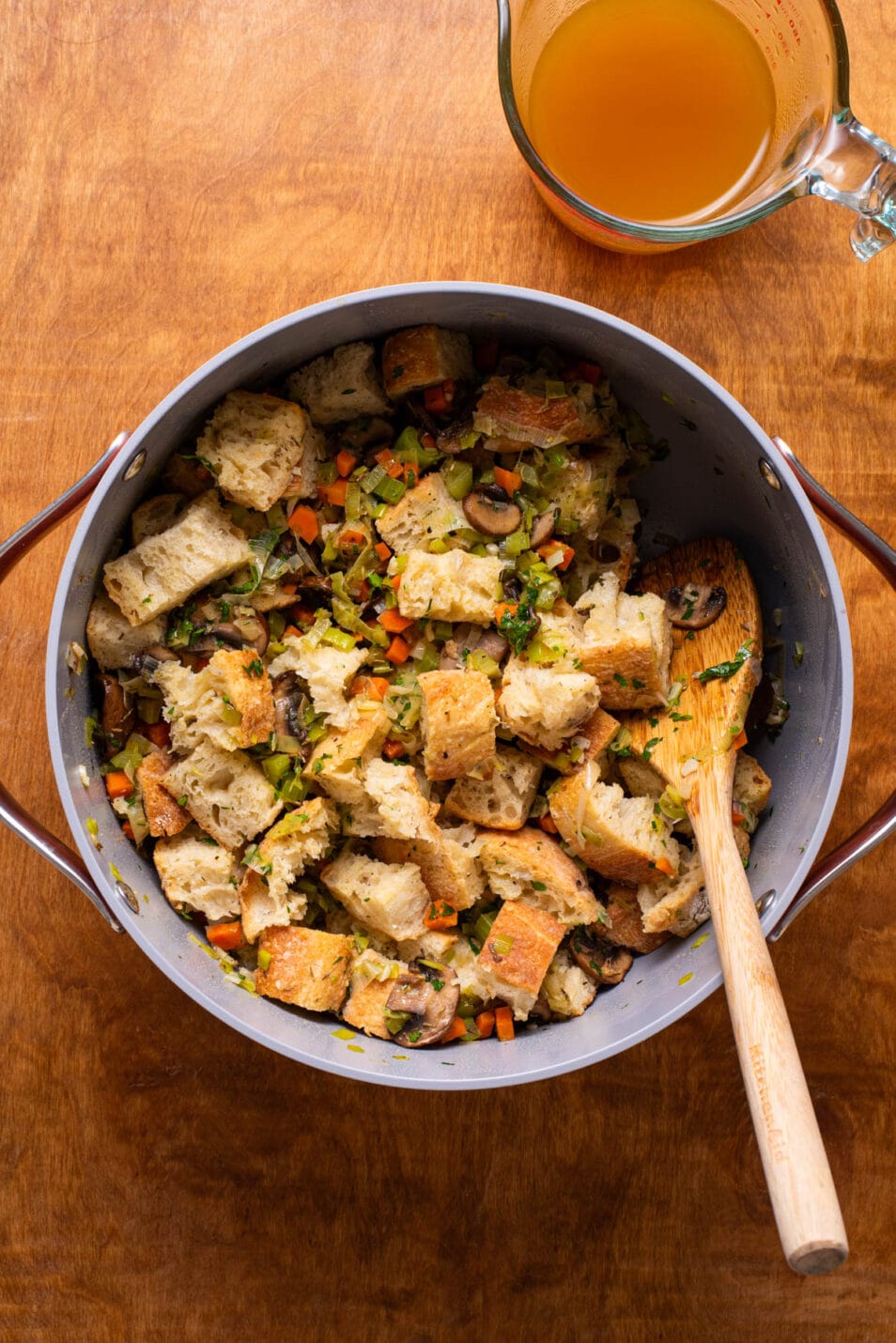 Combining stuffing ingredients in a Dutch oven.