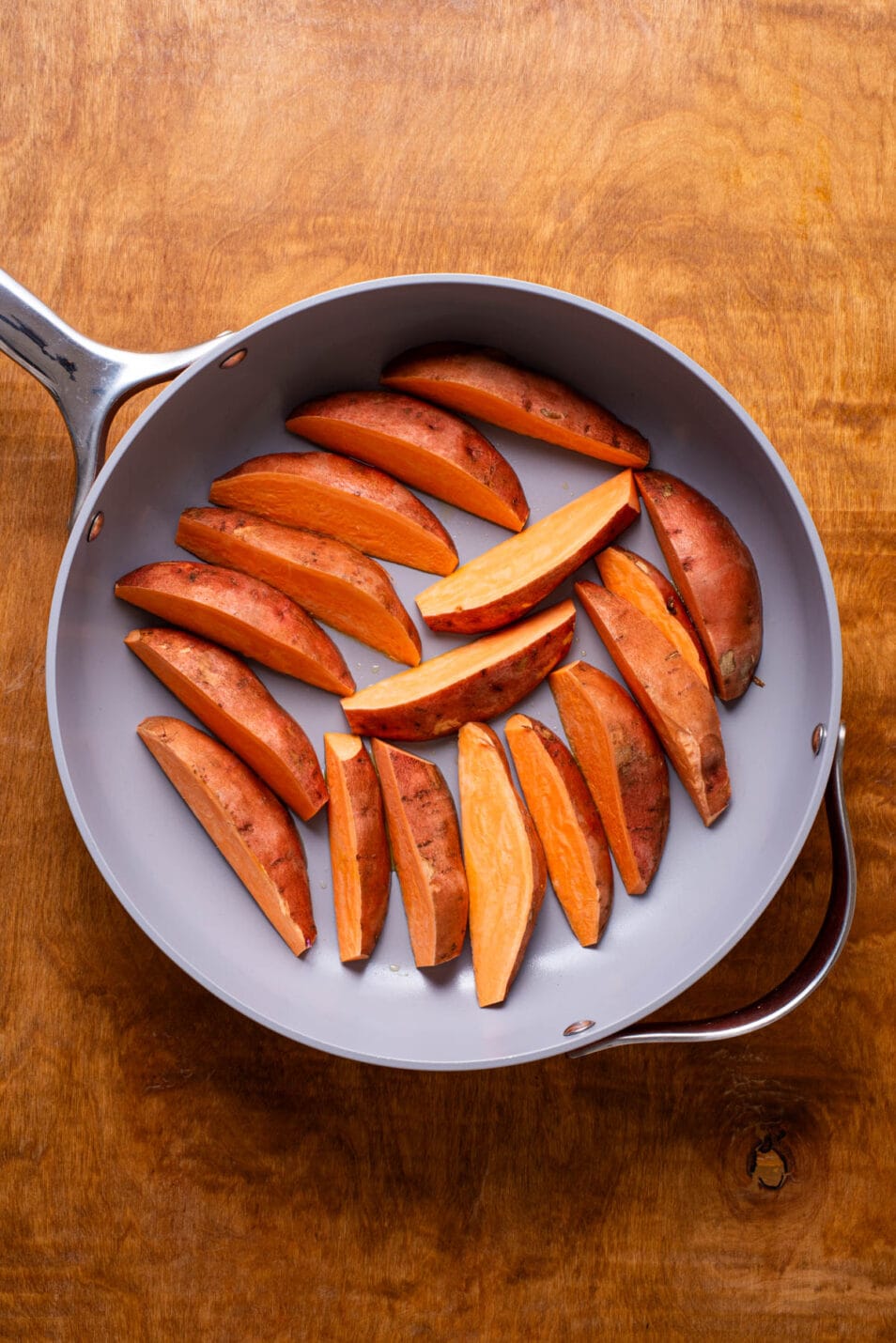 Sweet potato wedges in a skillet.