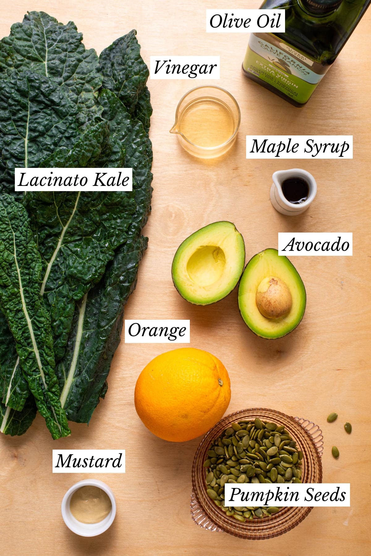 Ingredients gathered to make a kale-orange salad with avocado.