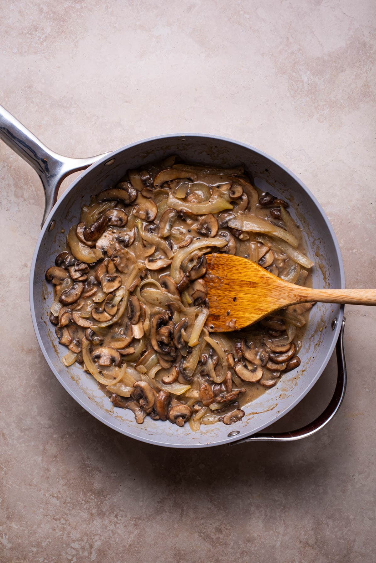Creamy mushrooms and onions in a skillet.