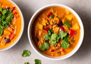 Vegan Thai-inspired tempeh curry in bowls, garnished with cilantro.