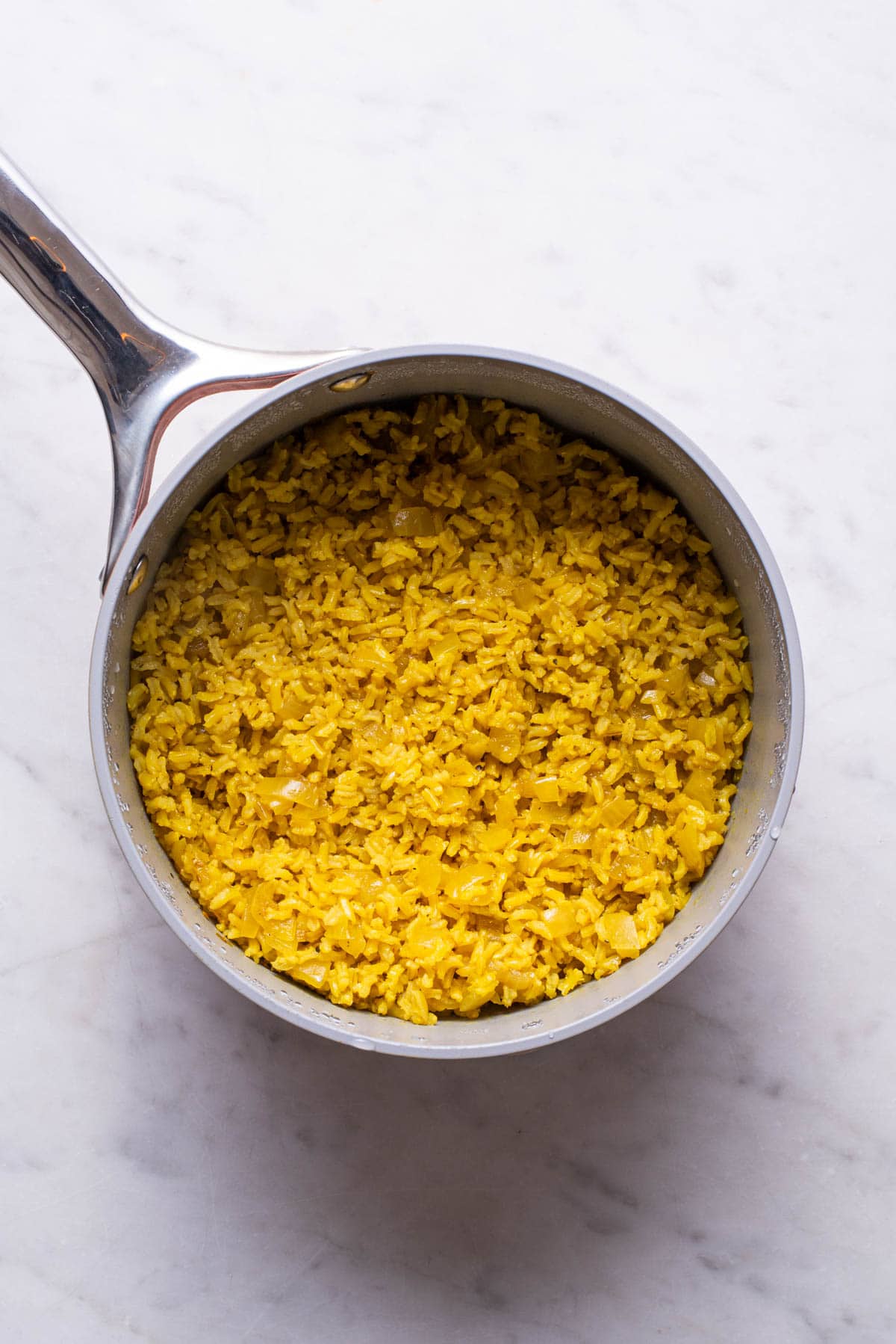 Cooked Indian yellow rice in a pot.