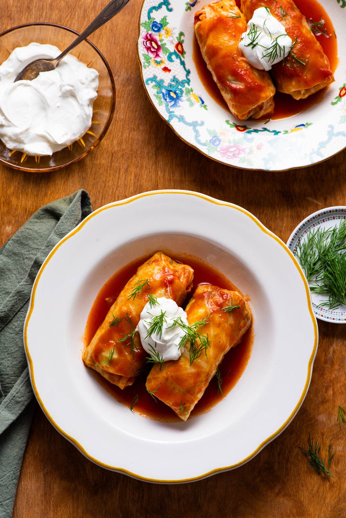 Vegetarian cabbage rolls served with tomato sauce and sour cream.