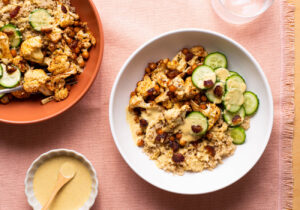 Roasted cauliflower and chickpea quinoa bowls with tahini dressing, cucumbers, and dates.