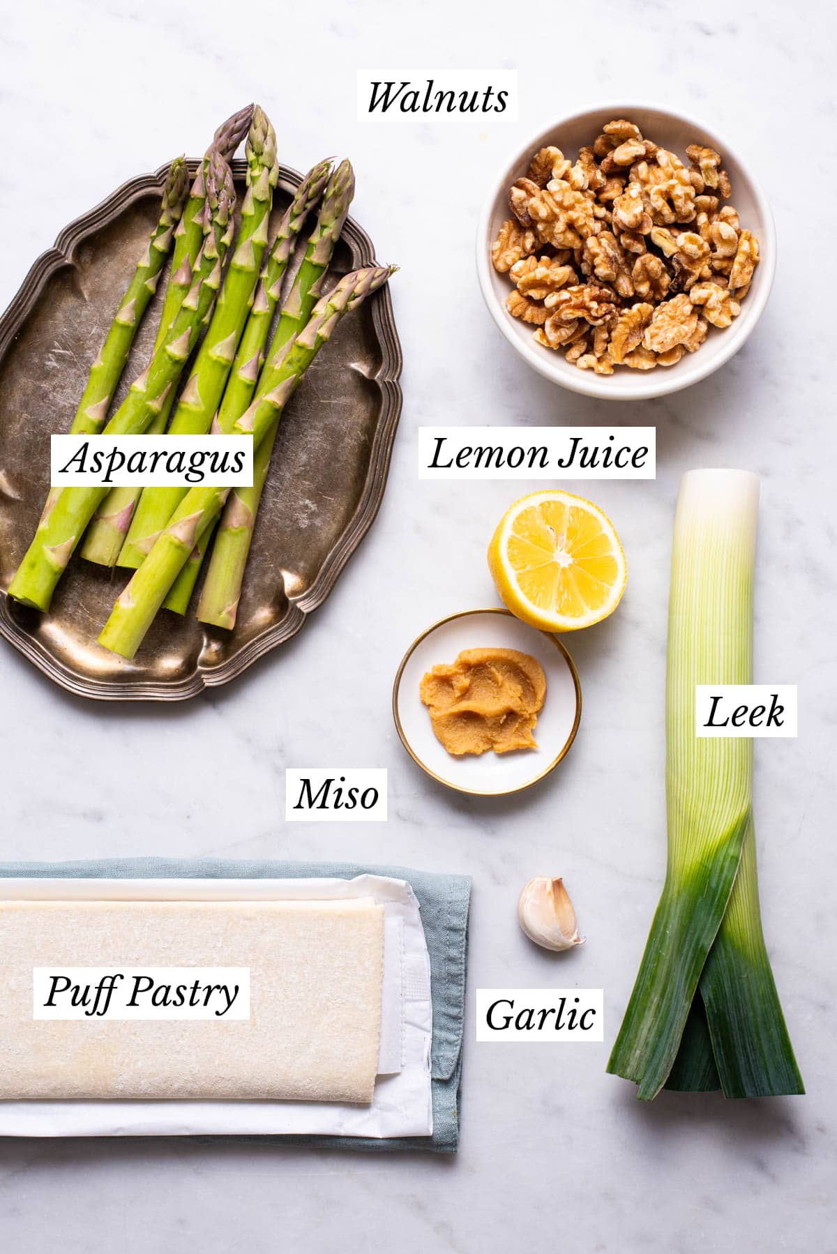 Ingredients gathered to make a vegan puff pastry tart with asparagus and leek.