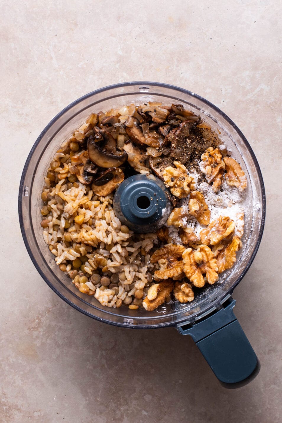 Lentils, brown rice, mushrooms, and walnuts in a food processor.