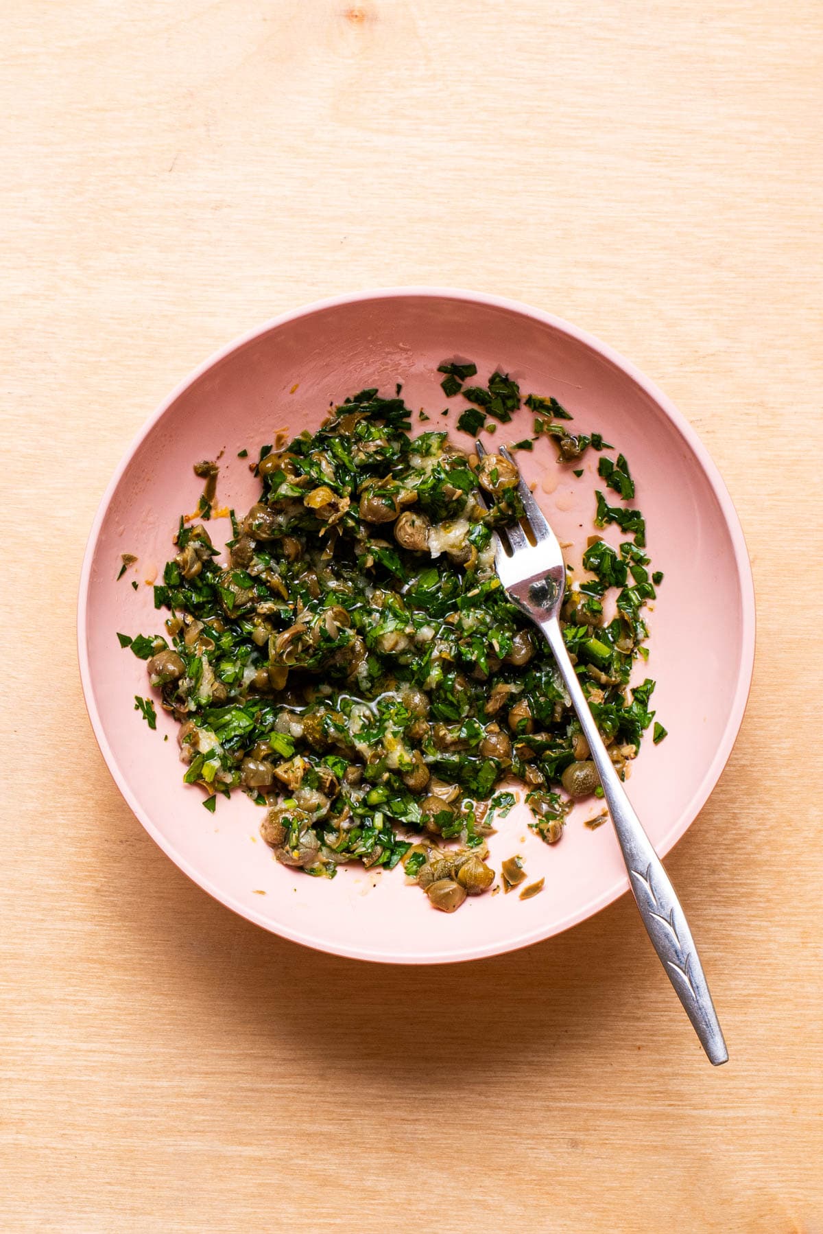 Caper-parsley relish in a pink bowl.