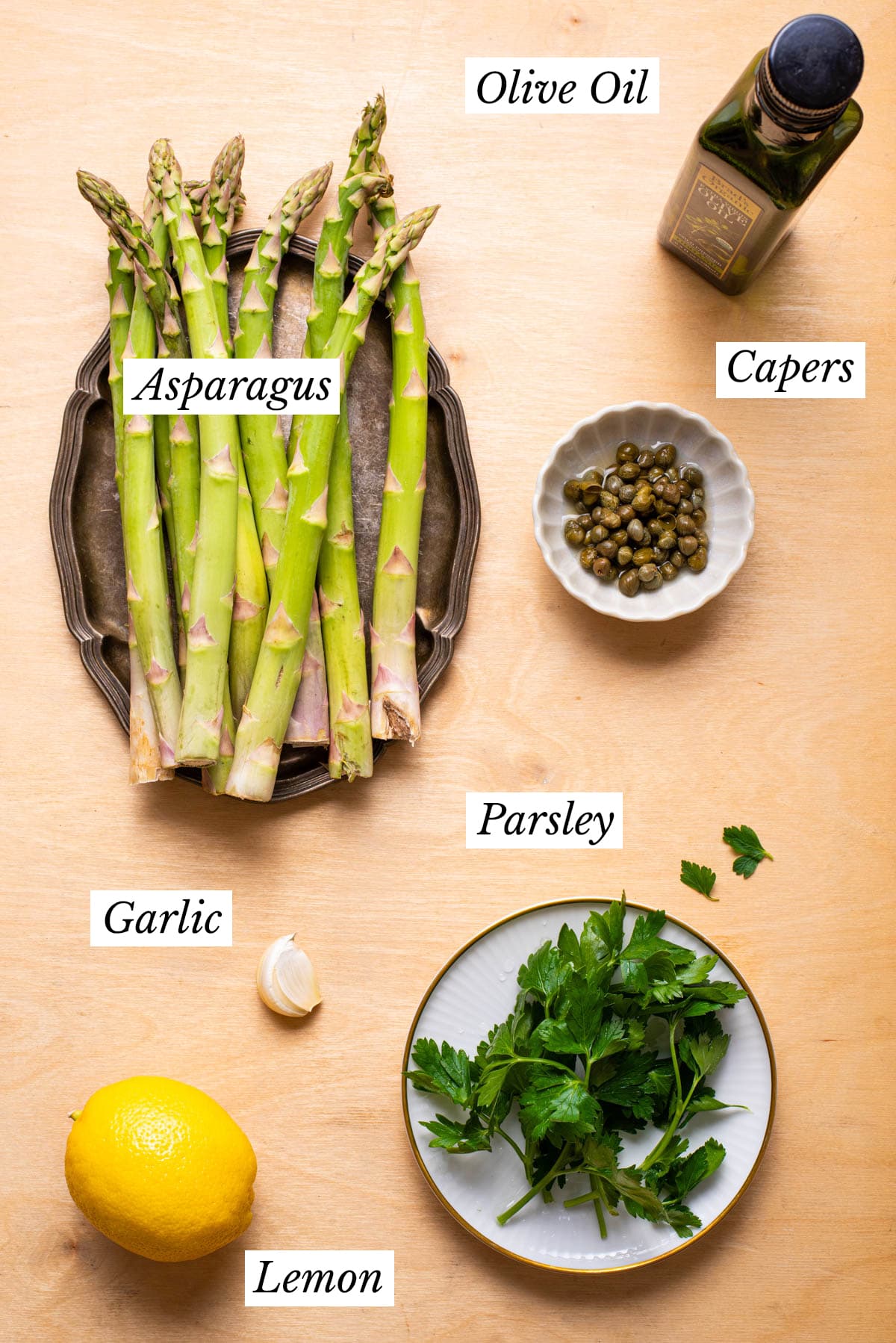 Ingredients gathered to make pan-fried asparagus with lemon and parsley.